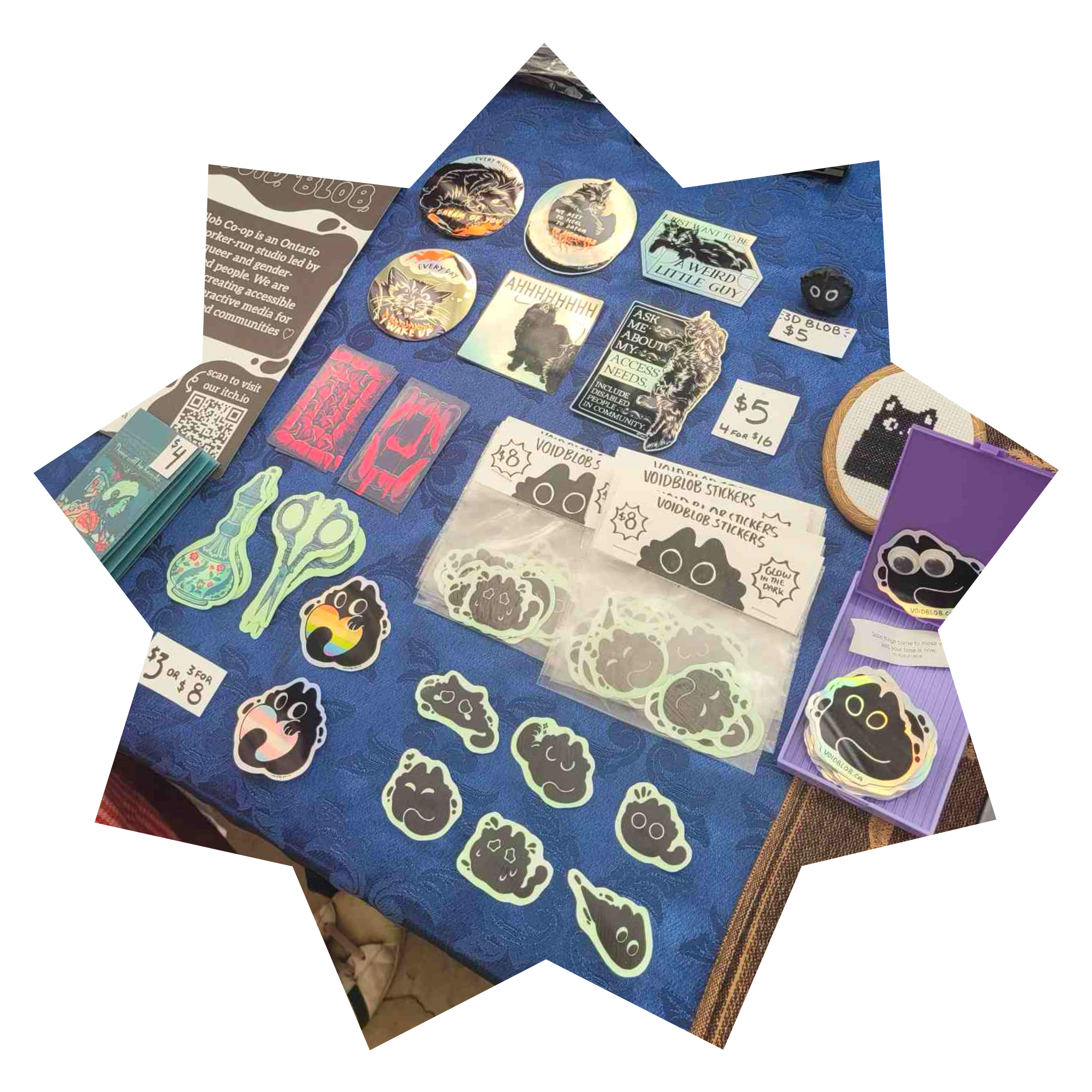 A table spread with a dark blue table cloth with a collection of stickers featuring black cats